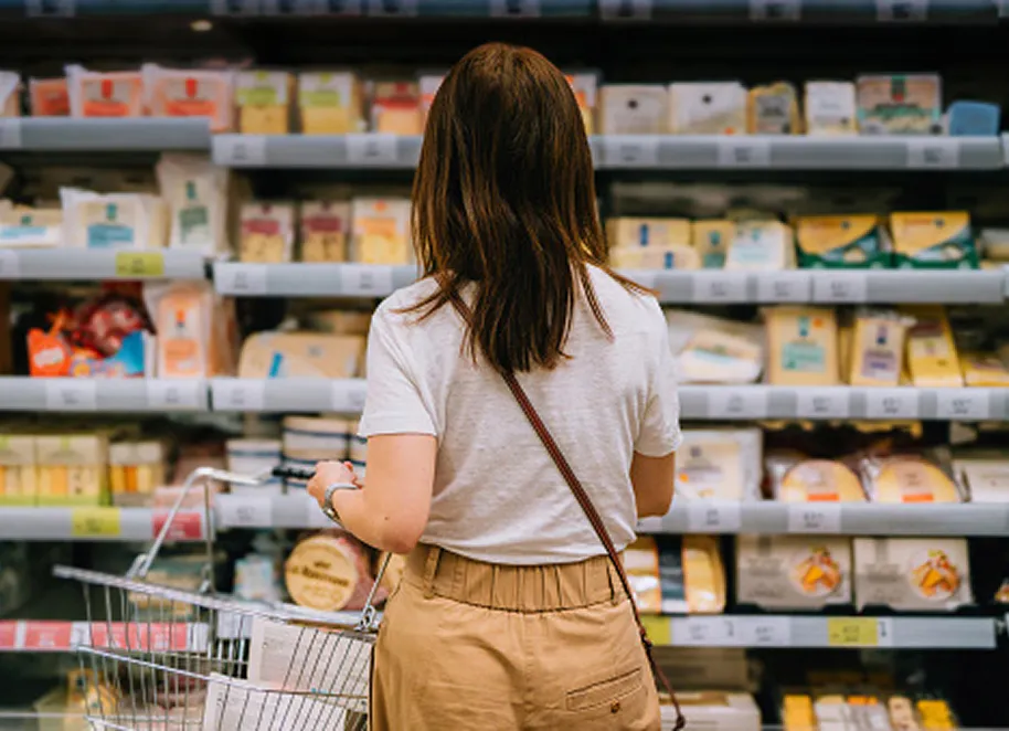 woman with back toward camera in shopping aisle