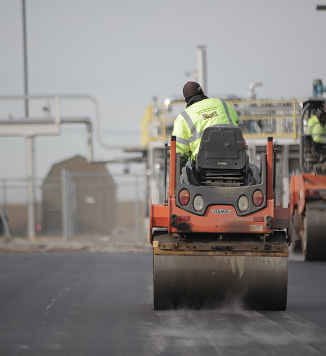steam roller back shot in front farm complex